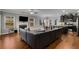 Open-concept living area connecting to the kitchen and dining, featuring a fireplace and ample natural light at 3475 Summerlin Pkwy, Lithia Springs, GA 30122