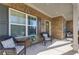 Inviting covered porch with comfortable wicker seating, perfect for relaxing and enjoying the outdoors at 3475 Summerlin Pkwy, Lithia Springs, GA 30122