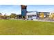 View of a rooftop bar and restaurant overlooking a green lawn area at 3475 Summerlin Pkwy, Lithia Springs, GA 30122