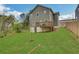 Spacious backyard with a well-maintained lawn, a back deck, and a newly planted sapling at 1944 Lakewood Se Ter, Atlanta, GA 30315