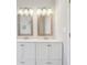 Bathroom featuring a dual sink vanity with framed mirrors and modern lighting at 1944 Lakewood Se Ter, Atlanta, GA 30315