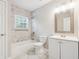 Bathroom features a tub with shower, white vanity, and neutral toned walls and flooring at 1944 Lakewood Se Ter, Atlanta, GA 30315
