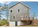 Exterior of home featuring a back deck, windows, gray siding, and a door leading to the basement at 1944 Lakewood Se Ter, Atlanta, GA 30315