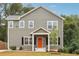 Well-maintained two-story home featuring a covered porch, symmetrical windows, and a neatly landscaped front yard at 1944 Lakewood Se Ter, Atlanta, GA 30315