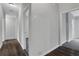 Hallway with wood-style flooring, gray walls, and doorways leading to other rooms with neutral carpeting at 1944 Lakewood Se Ter, Atlanta, GA 30315