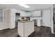 Modern kitchen featuring white cabinets, an island, stainless steel appliances, and hardwood floors at 1944 Lakewood Se Ter, Atlanta, GA 30315