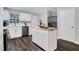 Well lit kitchen featuring white cabinets, island, stainless steel appliances, and hardwood floors at 1944 Lakewood Se Ter, Atlanta, GA 30315