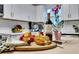 Close-up of kitchen island with cheese, bread, wine, and decorative dishware at 1944 Lakewood Se Ter, Atlanta, GA 30315