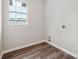 Empty laundry room with wood-look floor, window, and hookups ready for washer and dryer at 1944 Lakewood Se Ter, Atlanta, GA 30315