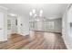 Bright, open living room featuring hardwood floors, neutral walls, chandelier, and multiple windows at 1944 Lakewood Se Ter, Atlanta, GA 30315