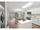 Open-concept living space with hardwood floors, modern kitchen, dining area, and stainless steel appliances at 1944 Lakewood Se Ter, Atlanta, GA 30315