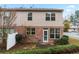 The backyard features a mix of brick and siding, and mature trees at 3879 Brockenhurst Dr, Buford, GA 30519