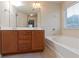 Bathroom with double vanity, tub, and large mirror at 3879 Brockenhurst Dr, Buford, GA 30519