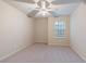 Clean bedroom with ceiling fan and natural light from a large window at 3879 Brockenhurst Dr, Buford, GA 30519