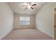 Spacious bedroom with carpet, ceiling fan and large window providing natural light at 3879 Brockenhurst Dr, Buford, GA 30519