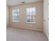 Neutral bedroom with two windows, carpet and light colored walls at 3879 Brockenhurst Dr, Buford, GA 30519
