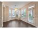 Cozy dining area with bright light fixture and many windows at 3879 Brockenhurst Dr, Buford, GA 30519