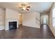 Bright living room with fireplace, ceiling fan, and staircase at 3879 Brockenhurst Dr, Buford, GA 30519
