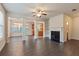 Spacious living area with hardwood floors, fireplace, and open to dining area at 3879 Brockenhurst Dr, Buford, GA 30519