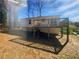 Exterior: Rear view of home with a wooden deck attached at 5216 Sweet Air Ln, Stone Mountain, GA 30088
