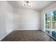 Bright dining room with modern lighting and sliding glass doors to a deck at 5216 Sweet Air Ln, Stone Mountain, GA 30088