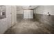 Empty two car garage with concrete floors and block walls at 5216 Sweet Air Ln, Stone Mountain, GA 30088