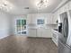 Modern kitchen with white cabinets, stainless appliances, and access to outdoor space at 5216 Sweet Air Ln, Stone Mountain, GA 30088