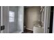 Bathroom featuring double sinks, a walk-in shower with marble tile and modern finishes at 884 Thurmond Nw St, Atlanta, GA 30314