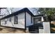 Side view of a white house with black trim, black steps and a short white fence at 884 Thurmond Nw St, Atlanta, GA 30314