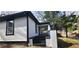 Side view of a white house with black trim, black steps and a short white fence at 884 Thurmond Nw St, Atlanta, GA 30314
