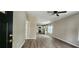 Open concept living room with wood floors and access to the kitchen with stainless steel appliances at 884 Thurmond Nw St, Atlanta, GA 30314