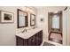Dual sink bathroom with a marble countertop and a view of a walk-in closet at 1438 Janmar Rd, Snellville, GA 30078