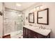 Bathroom featuring a marble-top vanity and a glass enclosed shower with tile surround at 1438 Janmar Rd, Snellville, GA 30078