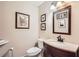 Chic powder room with dark wood vanity and decorative mirror at 1438 Janmar Rd, Snellville, GA 30078
