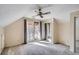 Bedroom with private balcony, mirrored closet doors, and neutral carpeting at 1438 Janmar Rd, Snellville, GA 30078
