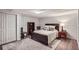 Bright bedroom featuring a large bed, hardwood floors, and ample closet space at 1438 Janmar Rd, Snellville, GA 30078