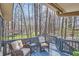 Outdoor deck with seating offers tranquil views of the surrounding wooded landscape at 1438 Janmar Rd, Snellville, GA 30078