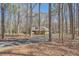 Long driveway through a wooded lot leads to this well-maintained home with stone and siding details at 1438 Janmar Rd, Snellville, GA 30078
