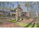 Charming home nestled among trees with deck, brick chimney, and lush landscaping at 1438 Janmar Rd, Snellville, GA 30078