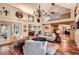 Spacious living room with high ceilings, beautiful hardwood floors, stone fireplace, and comfortable seating at 1438 Janmar Rd, Snellville, GA 30078