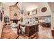 Open-concept living room with vaulted ceilings, stone fireplace, wood floors, chandelier, and access to kitchen at 1438 Janmar Rd, Snellville, GA 30078