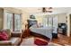 Serene main bedroom with large windows, ceiling fan, and seating area at 1438 Janmar Rd, Snellville, GA 30078