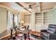 Home office boasts custom built-ins, hardwood floors, and coffered ceiling at 1438 Janmar Rd, Snellville, GA 30078
