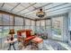 Bright sun room with comfortable wicker furniture is the perfect place to relax and unwind at 1438 Janmar Rd, Snellville, GA 30078