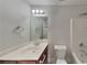 Well-lit bathroom with a modern vanity, a large mirror, and a shower-tub combination at 2413 Brynlynn Woods, Conyers, GA 30013
