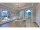 Bright dining room with wood floors, chandelier, and arched doorways, perfect for entertaining at 2413 Brynlynn Woods, Conyers, GA 30013