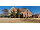 Beautiful two-story brick home with mature landscaping and a well-manicured lawn at 2413 Brynlynn Woods, Conyers, GA 30013