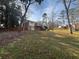 Large backyard featuring a deck, lush greenery, and ample space for outdoor activities at 2784 Williamsburg Way, Decatur, GA 30034