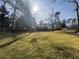 Expansive backyard with lush greenery, a deck, and a walk-out basement, offering outdoor living at 2784 Williamsburg Way, Decatur, GA 30034