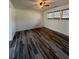 The basement room offers plank flooring, ceiling fan, and window with wooden blinds at 2784 Williamsburg Way, Decatur, GA 30034